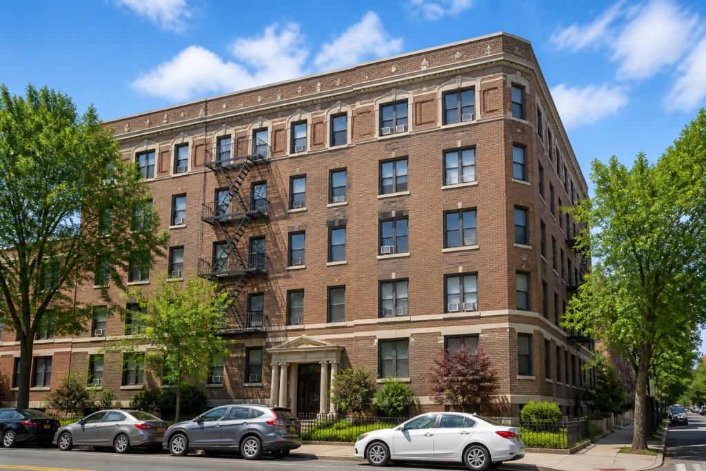 Brick apartment building with 5+ rental units in clear daylight, the kind of building commercial apartment insurance covers